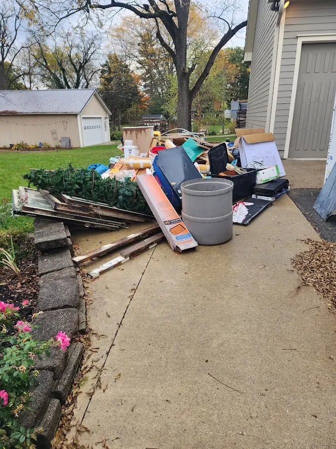 Dumpster being loaded with debris for 12 Yard Dumpster Rental in North Madison